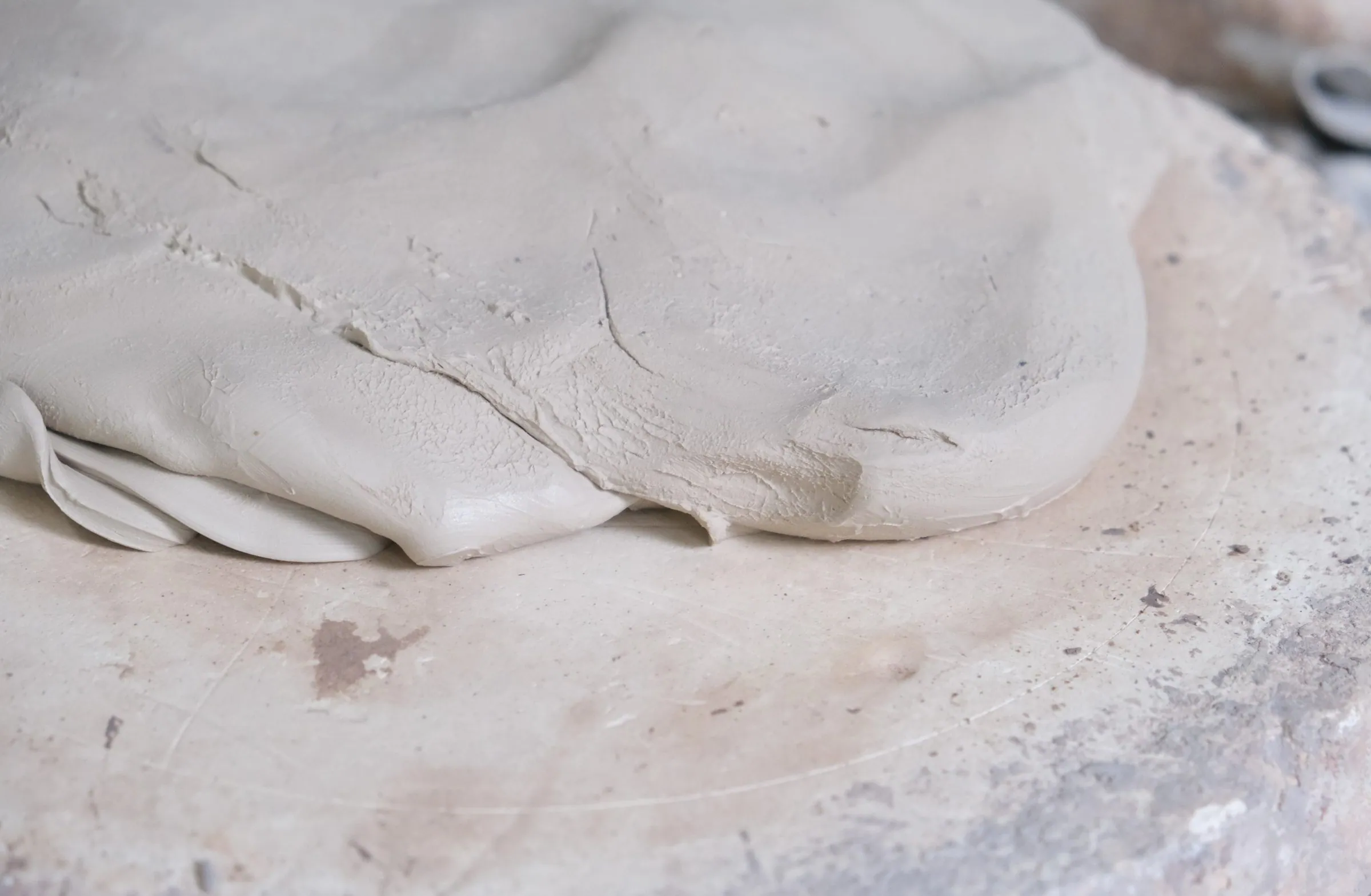 A sheet of smooth clay laid flat, in soft light