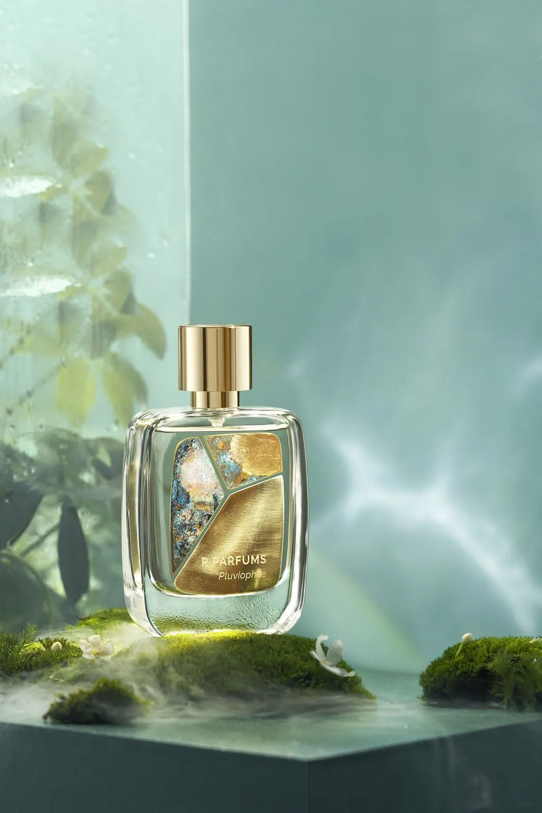 Pluviophile in the Patina on Brass bottle, its brass and patina pieces set on the glass, standing on moss