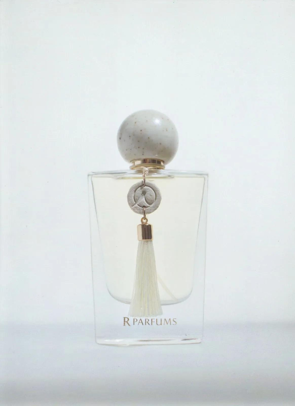Ceramic bottle with an ivory glazed cap and a white tassel