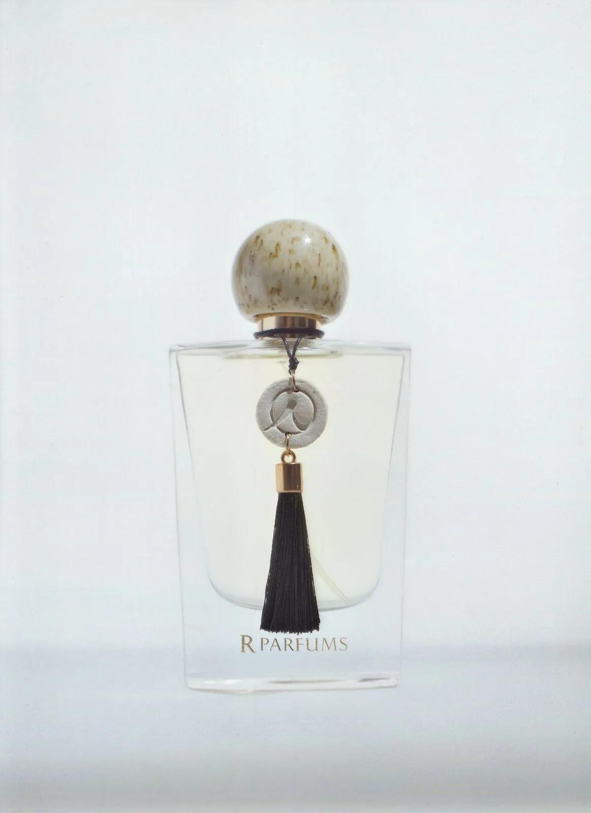 The Ceramic bottle: a speckled glaze cap and a black tassel, on a light ground