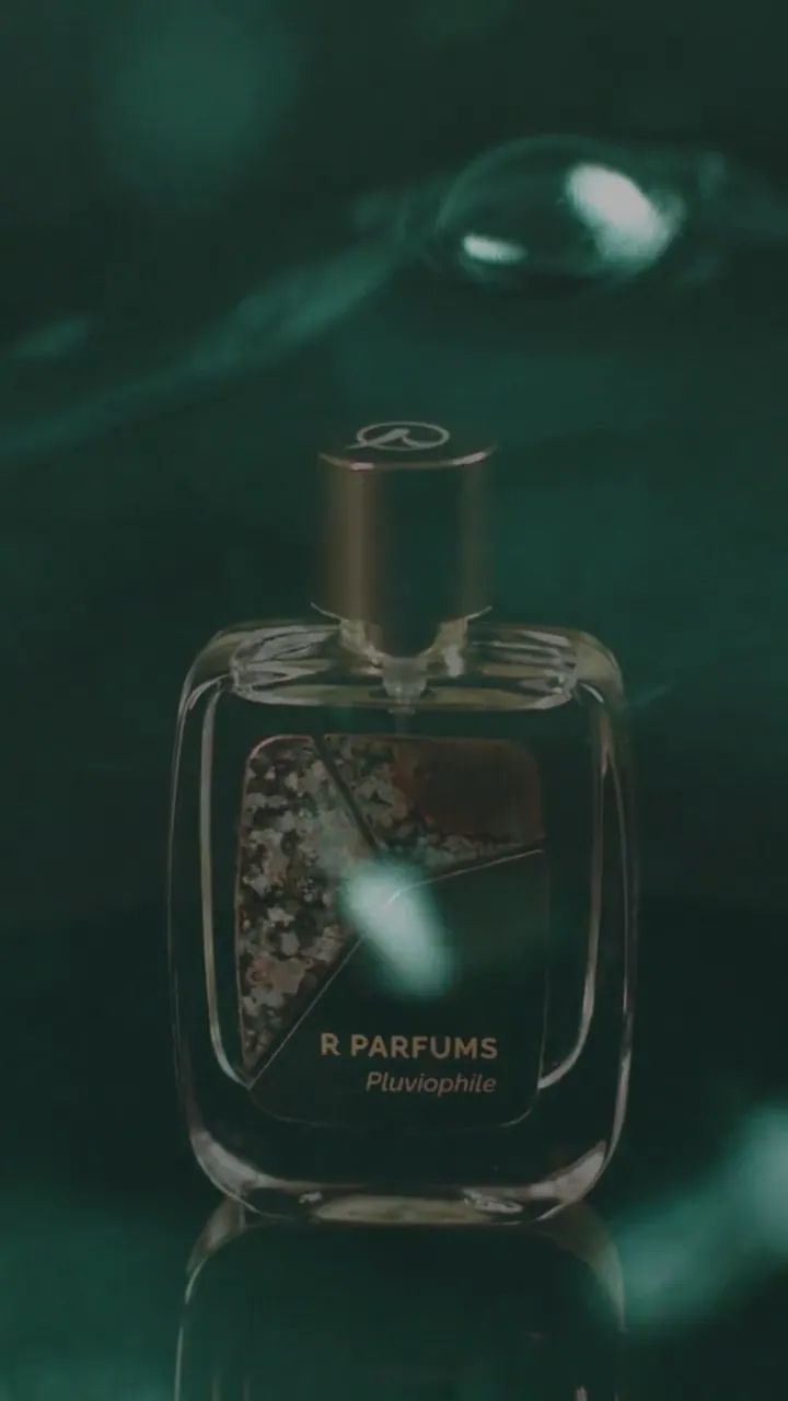 Film, 2022: Pluviophile in the Patina bottle among water and green leaves, set to music, looping with the sound off.